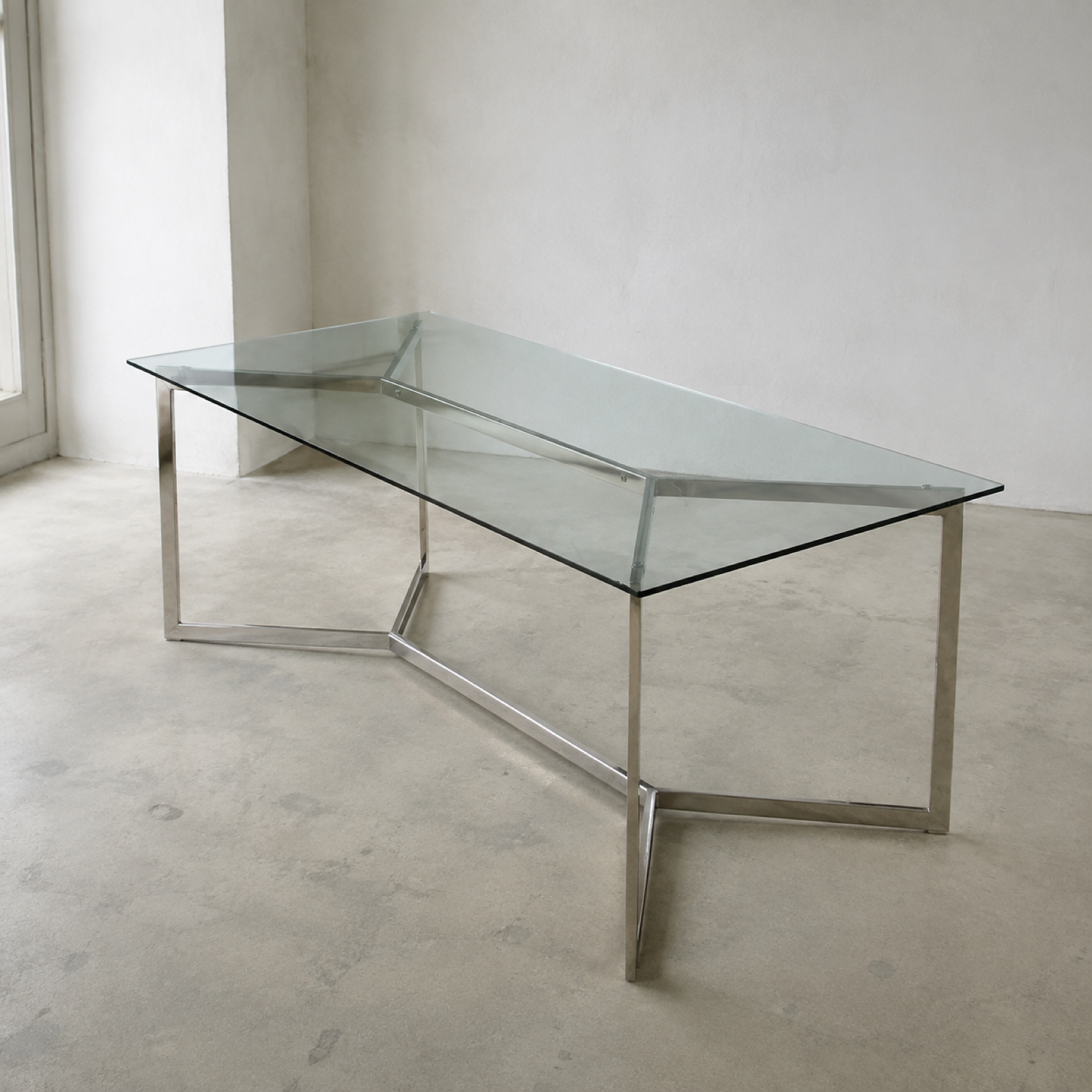 Strut Glass Dining Table in a minimal showroom