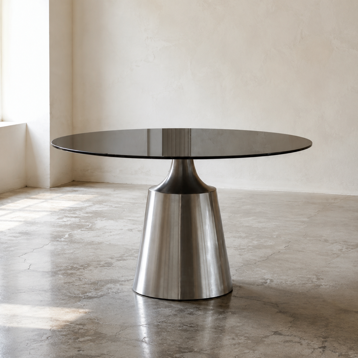 Taper Round Dining Table in a minimal showroom